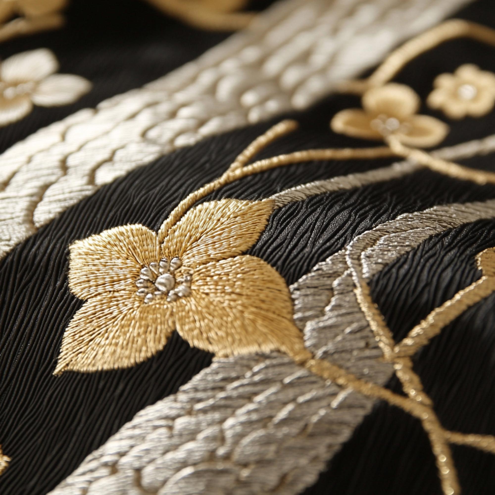 Close-up of gold thread hand embroidery on silk