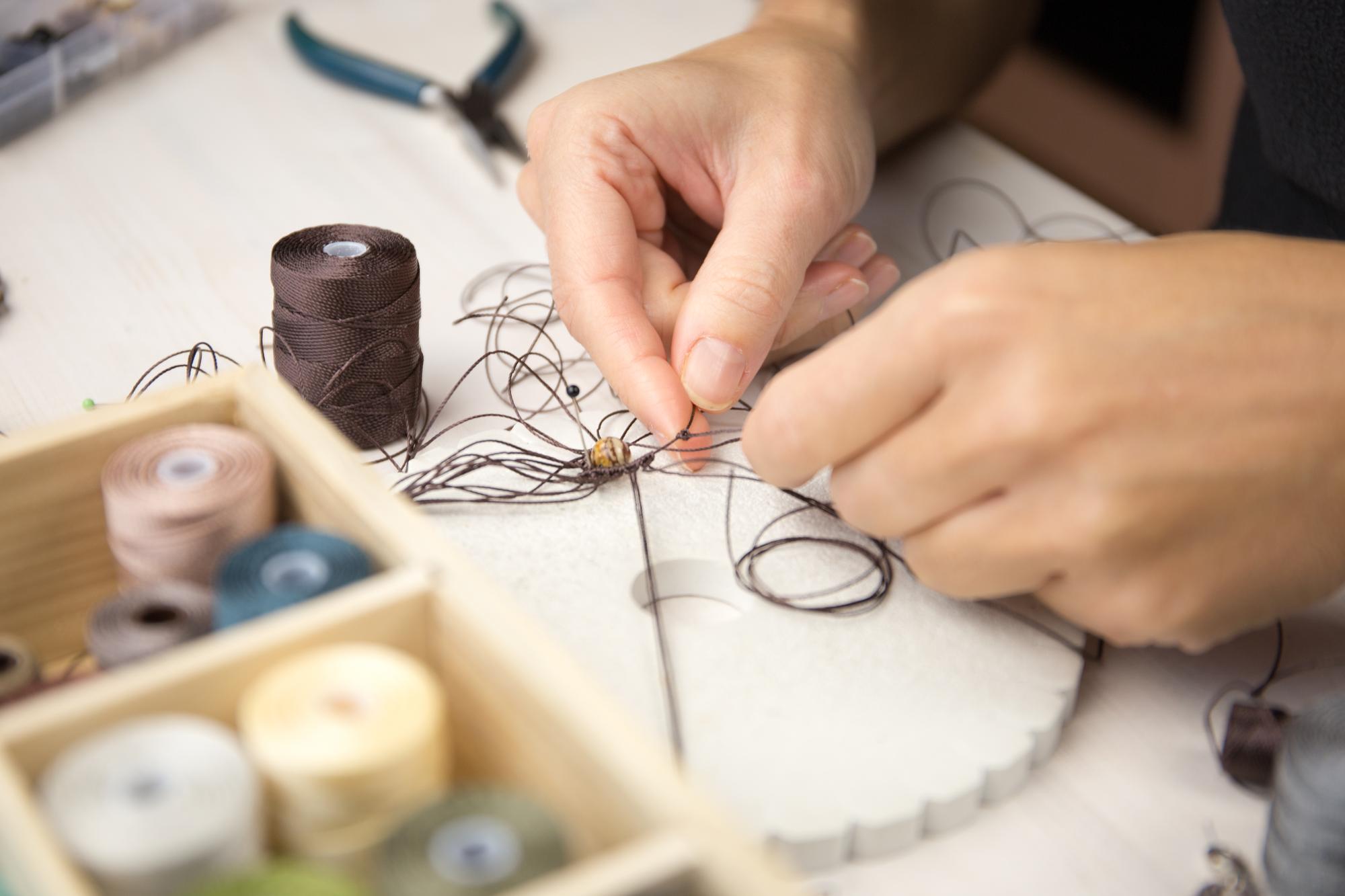 Workspace with thread spools and sketches